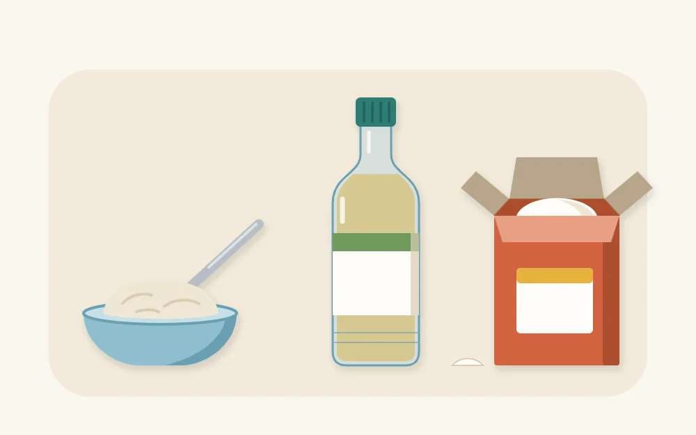 A small dish of paste with a spoon beside a bottle of cooking oil and an open box of baking soda