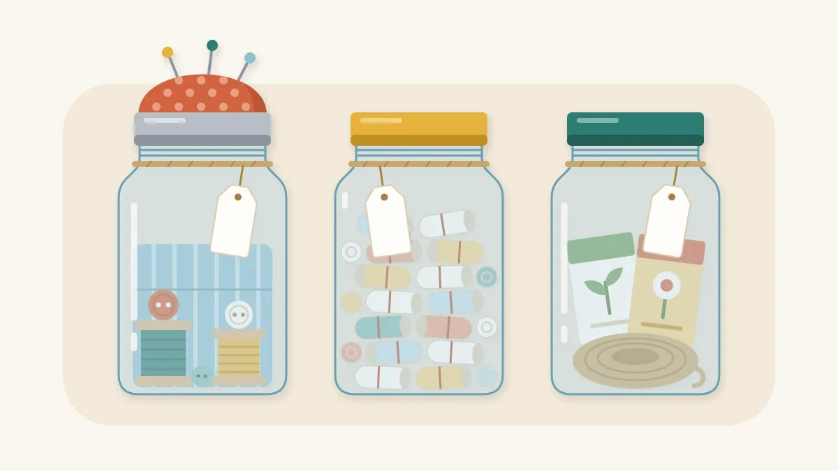 Three tagged gift jars: a pincushion-lid sewing kit, rolled paper slips, and seed packets with twine