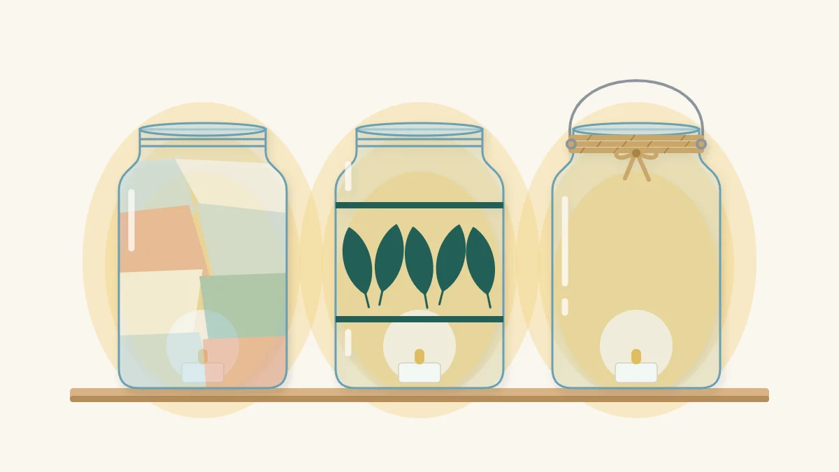 Three glowing jar lanterns: pale tissue paper, leaf silhouettes, and twine with a wire handle