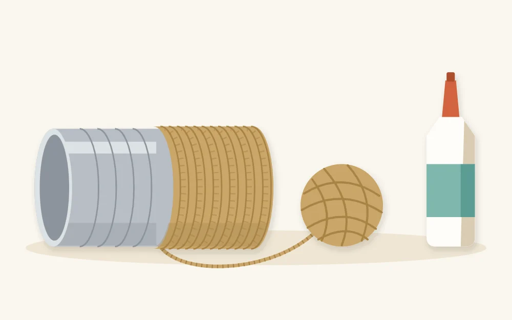 Tin can on its side half wrapped in twine beside a ball of twine and glue bottle